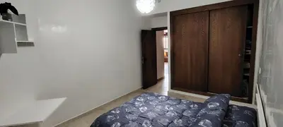 a room with a bed and a wooden door at Appartement Familial à Marrakech avec des espaces verts et 5 piscines in Marrakech