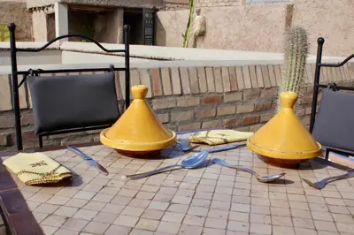 two yellow vases sitting on top of a patio at La Maison Berber Shams in Marrakech