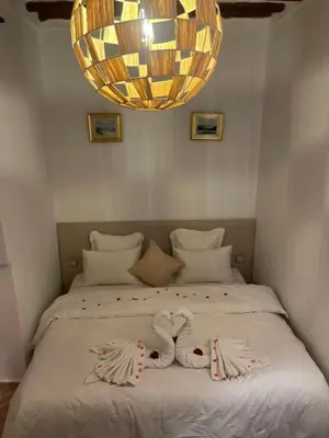 a bedroom with a bed with two towels on it at La Maison Berber Shams in Marrakech