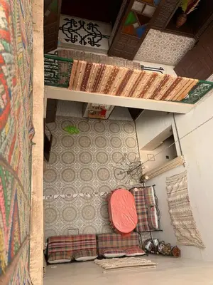 an overhead view of a room with a table and a couch at DAR SI AHMED Riad Typique avec Terrasse Panoramique et Vue Exceptionnelle in Marrakech