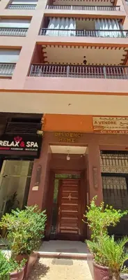 a building with a wooden door in front of it at Résidence hamza appartement 2 chambre in Marrakech