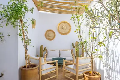 a room with a couch and chairs and plants at Riad YANNIS in Marrakech