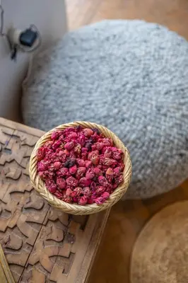 a basket of pink flowers sitting on a table at Riad YANNIS in Marrakech