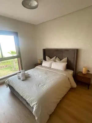 a bedroom with a large white bed with a window at Appartement luxueux à Prestigia SAPHIR in Marrakech
