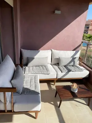 a living room with two couches and a table at Appartement luxueux à Prestigia SAPHIR in Marrakech