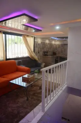 a living room with a couch and a table at medina View Apartment in Marrakech