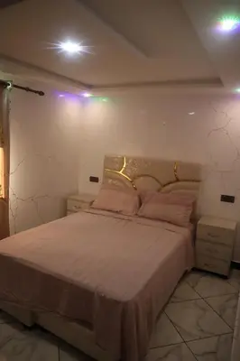 a bedroom with a large bed with lights on it at medina View Apartment in Marrakech