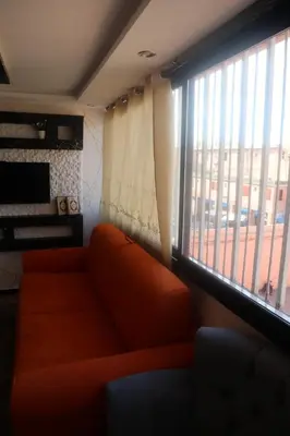 a living room with a couch and a large window at medina View Apartment in Marrakech