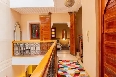 a hallway with a staircase with a rug on the floor at Charmant Riad privatif au cœur de la Médina in Marrakech