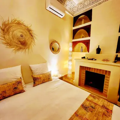 a bedroom with a bed and a fireplace at Riad Vilamoura & SPA in Marrakech