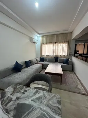 a living room with a couch and a table at Appartement 2 chambres Luxueuse centre Guéliz opr 15 in Marrakech
