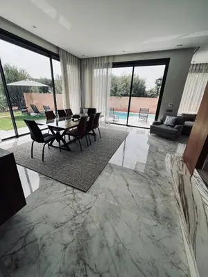 a large living room with a table and chairs at Dream villa in Marrakech