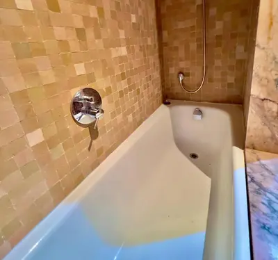 a bathroom with a bath tub with a shower at Palmeraie vue piscine 3 in Marrakech