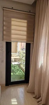 a window with a curtain in a room with a table at Firstwood Chic Apartment Hivernage in Marrakech