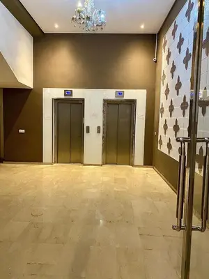 an empty lobby with three elevators and a flag at Apparemment 1 chambre salon à coté de la gare guéliz 20 in Marrakech