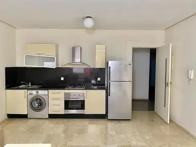 a kitchen with a refrigerator and a stove at Apparemment 1 chambre salon à coté de la gare guéliz 16 in Marrakech