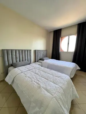 a bedroom with two beds and a window at Appartement 2 chambres salon à coté de la gare centre de guéliz 21 in Marrakech