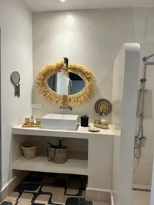 a bathroom with a white sink and a mirror at Riad Be Colors in Marrakech