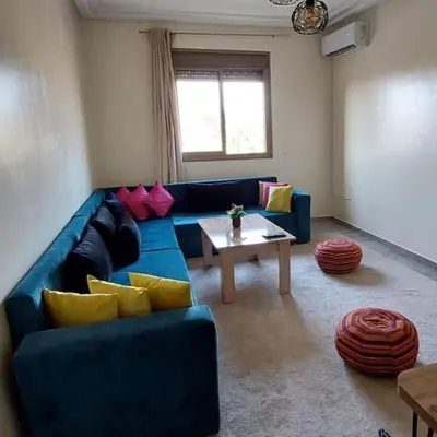 a living room with a blue couch and a table at Apartment in Marrakech - WiFI - IPTV Movies - equipped - free parking in Marrakech