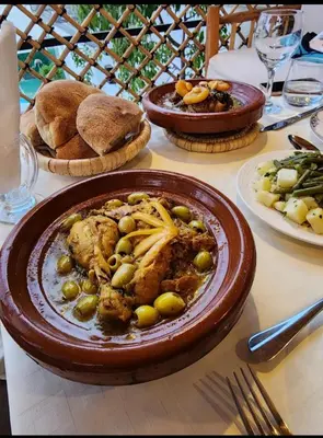 a table with a plate of food on a table at Riad Les Trois Mages in Marrakech