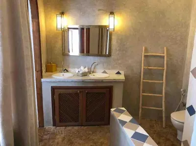 a bathroom with a sink and a mirror and a ladder at Riad Aslan Place des épices - en exclusivité, wifi in Marrakech