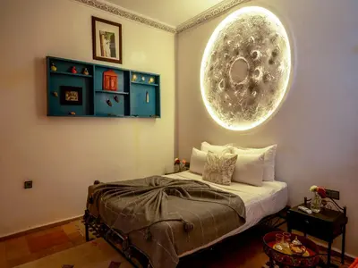a bedroom with a bed and a large orb on the wall at Riad Nakhla in Marrakech