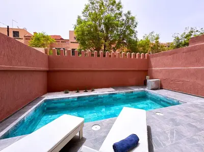 a swimming pool on a patio with a fence at Villa Jassmin, piscine, à 6km du centre ville in Marrakech