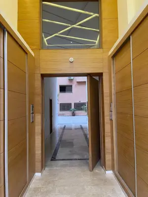 an empty hallway with wooden doors in a building at Appartement à louer Marrakech in Marrakech