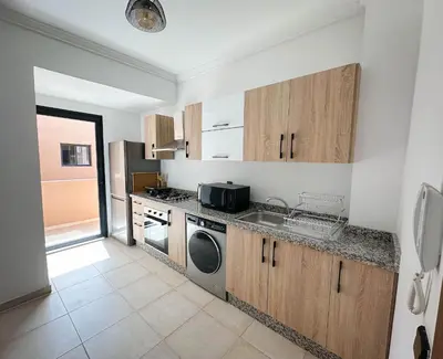 a kitchen with a sink and a dishwasher at Grand appartement moderne in Marrakech