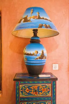 a blue vase sitting on a table with a lamp at Riad - In Medina - Kesh Design in Marrakech