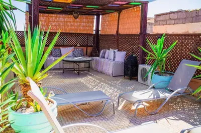 a patio with a table and chairs and plants at Riad - In Medina - Kesh Design in Marrakech