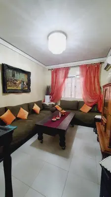 a living room with a couch and a table at Cozy Bedroom Sidi maarouf in Marrakech