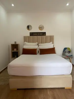 a bedroom with a large bed with white sheets and pillows at Nour 5 in Marrakech