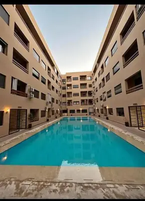 a large swimming pool in the middle of a building at Nour 5 in Marrakech