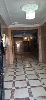a hallway with a checkered floor in a building at Résidence Nadia 3 étage appartement 22 in Marrakech