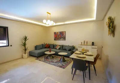 a living room with a couch and a table at Spacieux et luxueux appartement in Marrakech