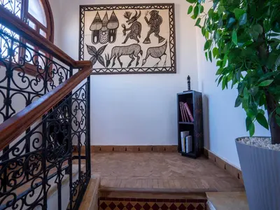 a room with a staircase with a picture of animals on the wall at Belle Riad de médina in Marrakech