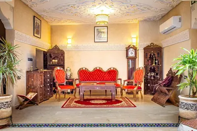 a living room with a red couch and chairs at Riad Brothers in Marrakech