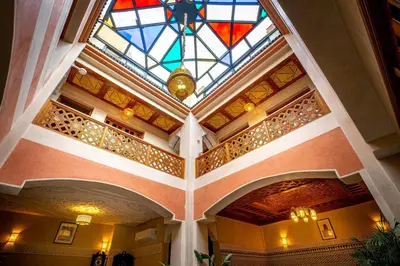 a building with a stained glass ceiling and a room at Riad Brothers in Marrakech