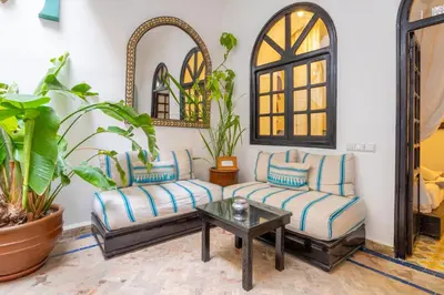 a living room with two couches and a table at Riad Sharqi Luminous A Sunny in Marrakech Old Town in Marrakech