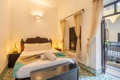 a bedroom with a large bed and a window at Riad Sharqi Luminous A Sunny in Marrakech Old Town in Marrakech