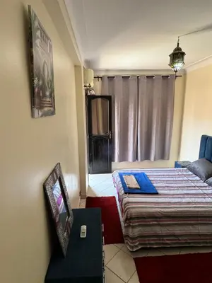 a hotel room with a bed and a window at Charmant Appartement à Gueliz - À Deux Pas des Attractions Locales in Marrakech