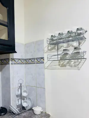 a kitchen with plates and dishes on a shelf at Charmant Appartement à Gueliz - À Deux Pas des Attractions Locales in Marrakech