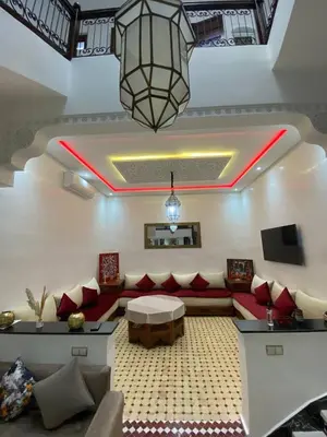 a living room with a couch and a table at Riad Camélia in Marrakech