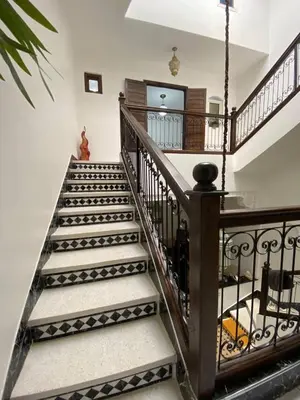 a staircase in a home with wrought iron railings at Riad Camélia in Marrakech