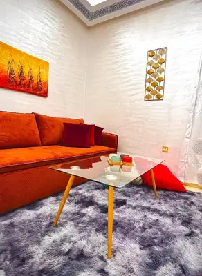a living room with a couch and a coffee table at Appartement LILIA in Marrakech