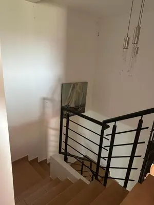 a room with a staircase with a picture on the wall at Luxury Duplex for Rent Suites,terrace,Swimimg Pool in Marrakech