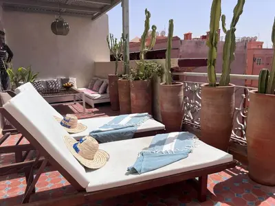 two tables with hats and napkins on a rooftop patio at RoofTop avec Terrasse Centre Gueliz in Marrakech