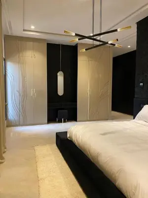 a bedroom with a large bed and a ceiling fan at Palmeria luxery in Marrakech