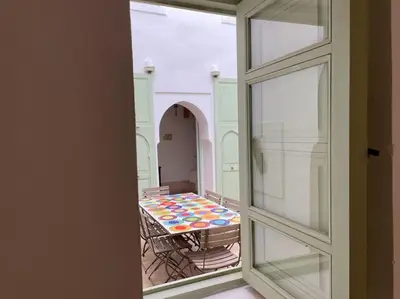 a view of a table through a window at Dar Ibo- Entire House- in Marrakech